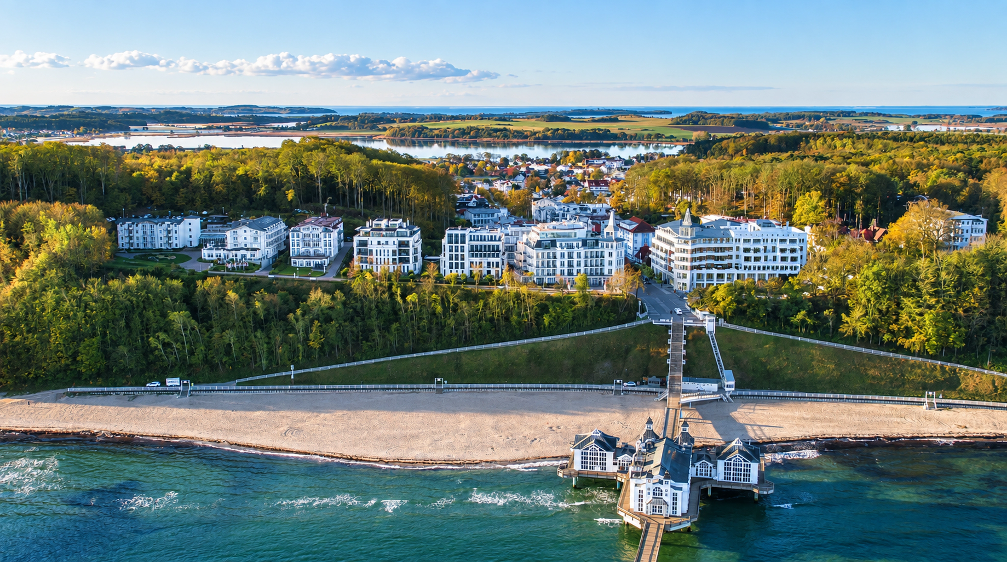 Aerial view of a coastal resort complex, beach and pier