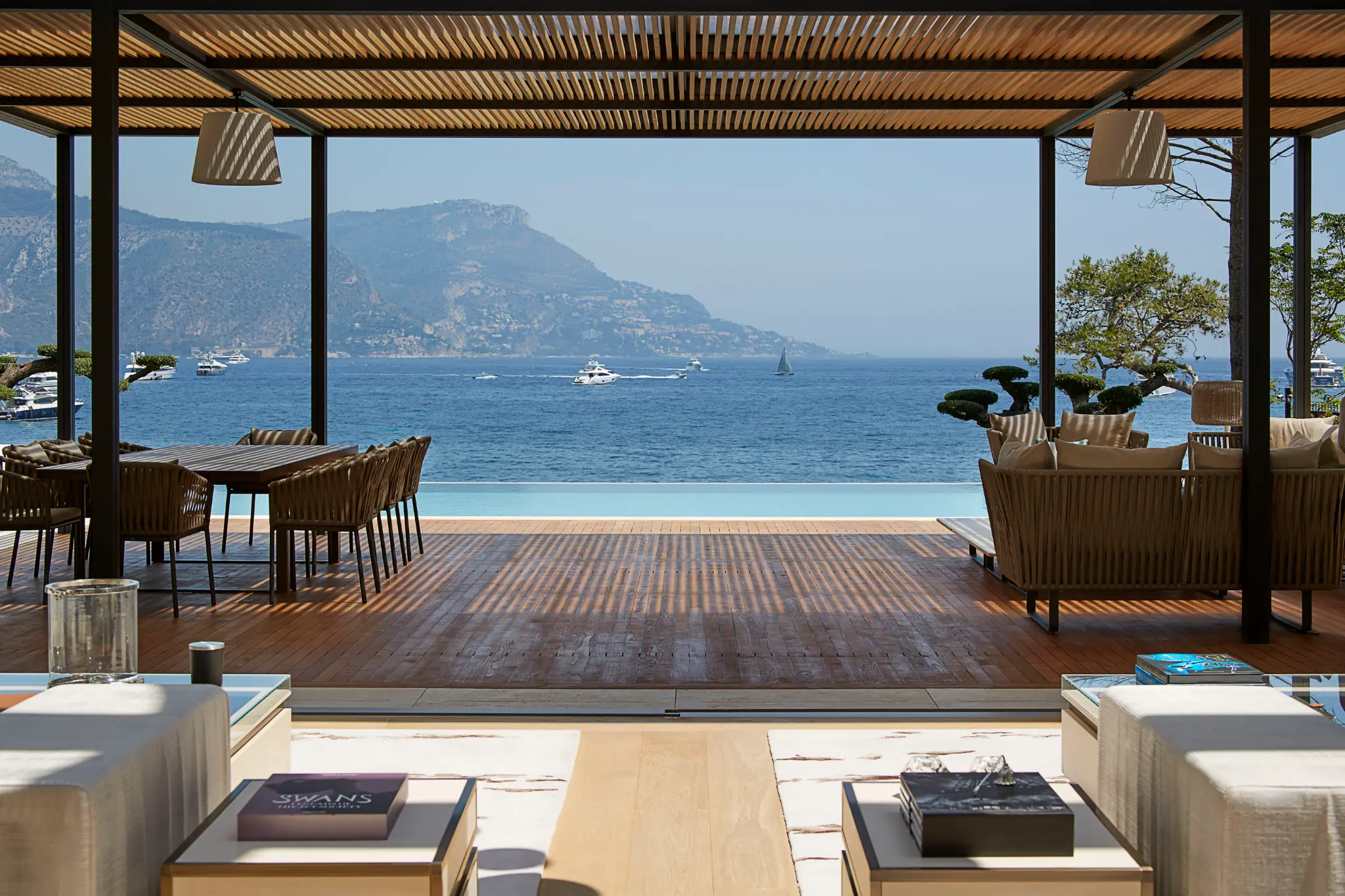 Sea-view terrace at Voile d’Or, with shaded dining and lounge seating